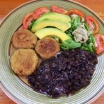 Dasheen puffs served with black beans & coconut cream, garden salad, avocado and pumpkin seed pate