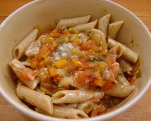 Whole-wheat pasta with tomato sauce and vegetables, topped with tahini